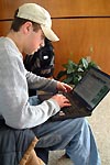 A student uses his laptop computer in a public lounge