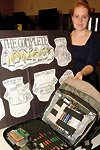 A student demonstrates her concept for storing art supplies