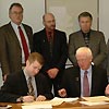 Leaders from UW-Stout and UW-Extension sign an agreement