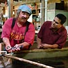 A researcher works with the owner of a local fish farm