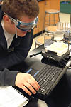 Student uses laptop equipped with LoggerPro software to complete a chemistry experiment.